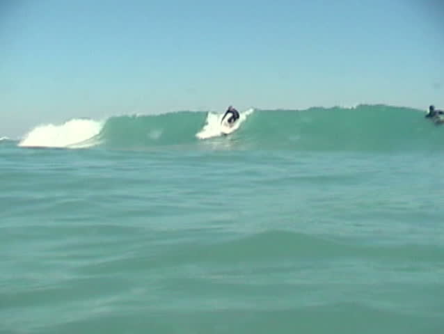 a close up underwater surfing turn.