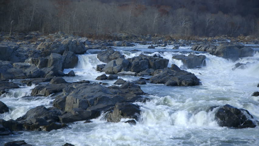 Huge boulders create whitewater rapids in a wilderness river.