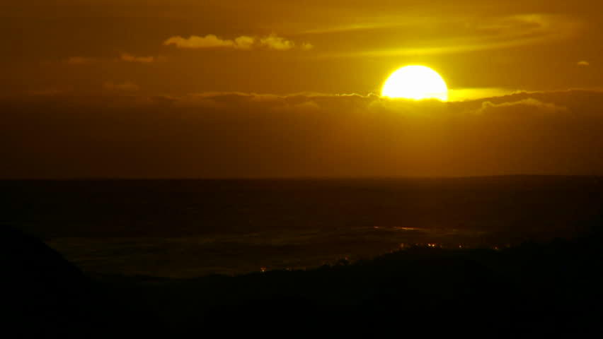 HAWAII, USA, 2012 The sunset behind waves as they crest and break in slow motion at sunset.