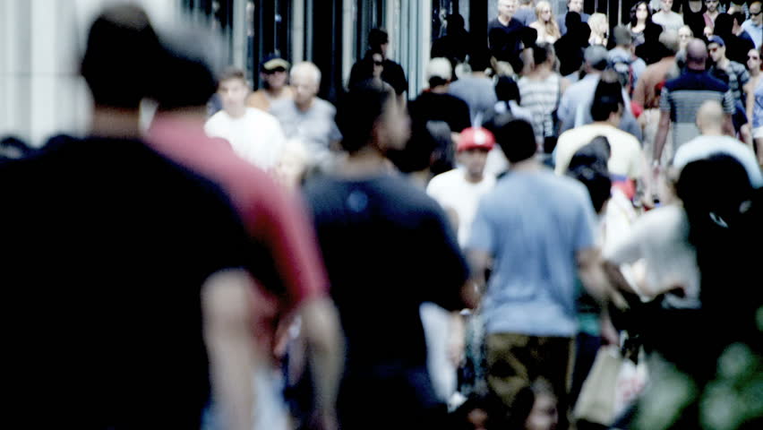 America - August 22, 2012: City population walking on busy sidewalks 