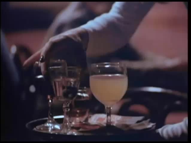 Waitress serving drinks to customers at table