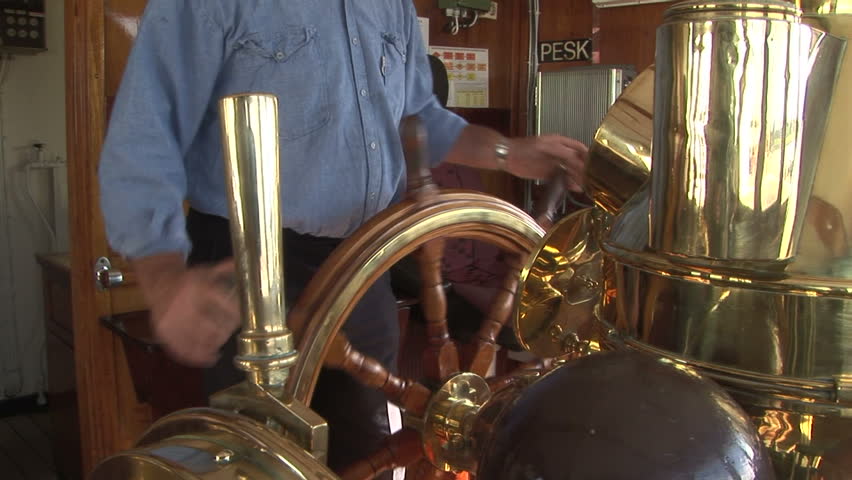Tugboat wheelhouse close-up with ship crewman