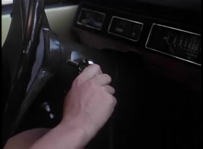 Close-up of hand turning key in the ignition