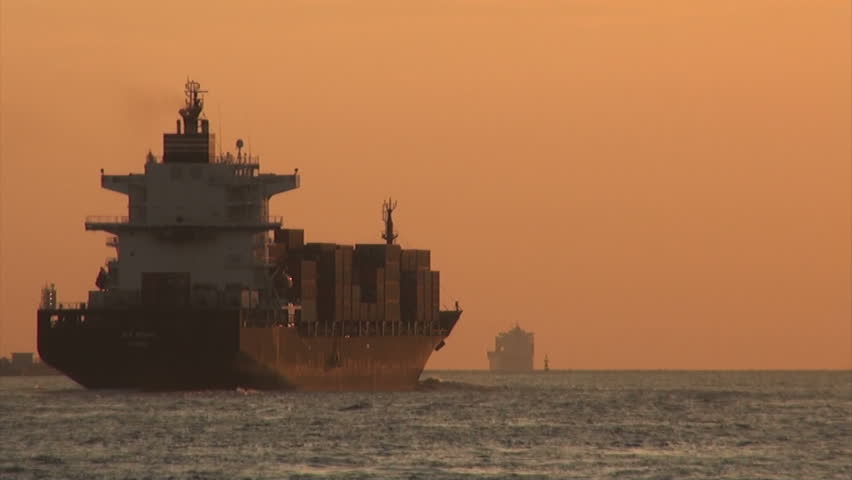 OSAKA, JAPAN - 26 OCTOBER 2012: A large freighter sails through the port of Osaka towards the ocean