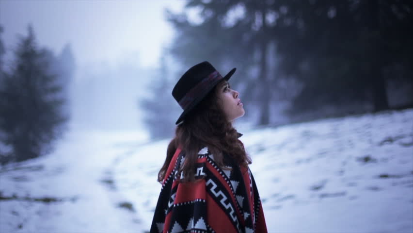 Brunette woman lost in snowy forest, scared searching for help