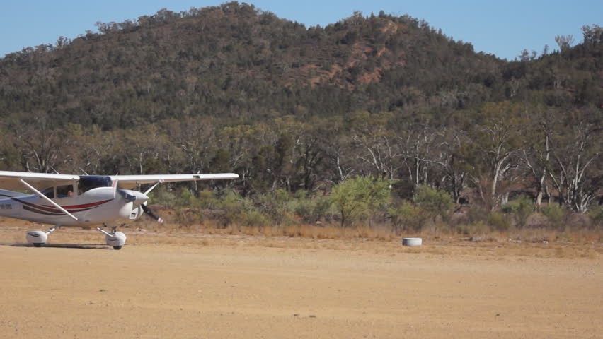 WILPENA POUND - JANUARY 20: Small airplane takes off from airstrip in January 20, 2013 in Wilpena, South Australia
