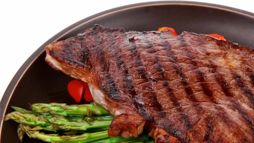 meat table : rare medium roast beef fillet with tomatoes and asparagus served on dish slow motion  hidef