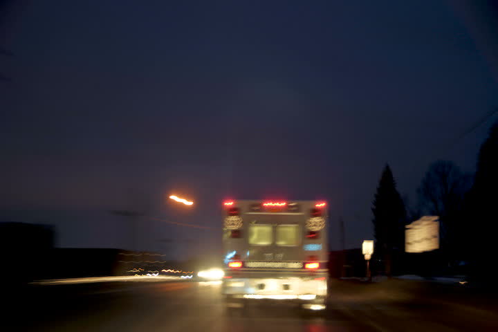 time-lapsed drive behind an on duty ambulance as it makes it's way through town to the hospital. Lights are on, but not flashing.