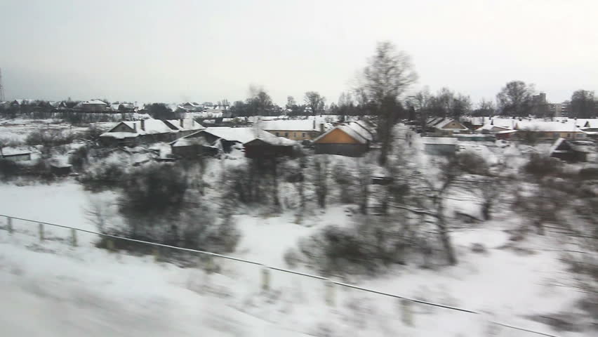 View from window of high-speed train Sapsan at the village, meandering river in the winter (High angle) POV
