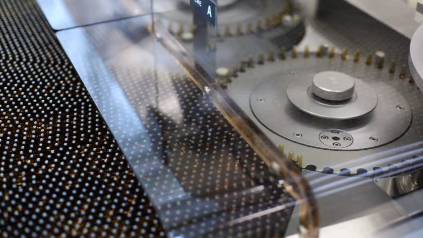 Automatic optical inspection machine, inspects vials and ampoules for particulates in liquid and container defects.