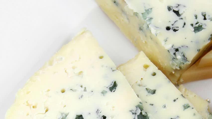 french delicatessen aged cheeses chops served on white plate with slices hidef slow motion intro