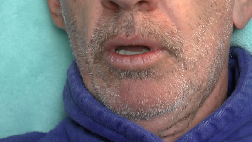 Coughing man, ill with severe bronchitis, chest infection, swallows liquid cough medicine from plastic cup, for relief. 1080p