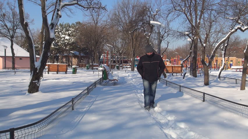Depressed Man Walking Alone on the Path in Park, Sad Man Stepping in Snow