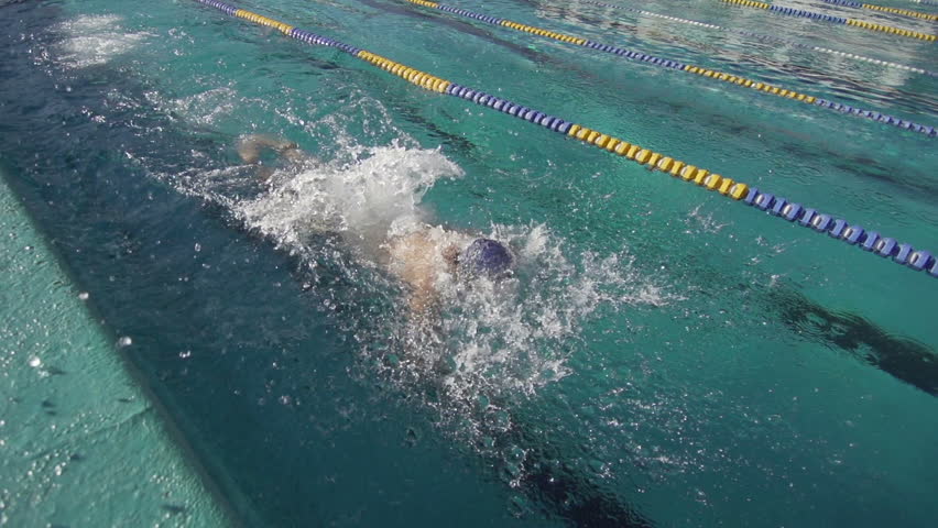 Professional Swimmer Training The Butterfly Stroke. Close Shot In Slow Motion.