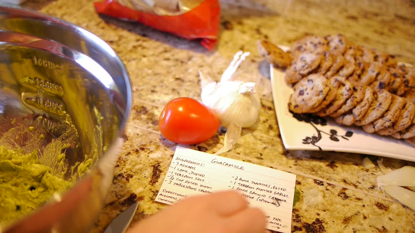 Woman reads recipe for guacamole