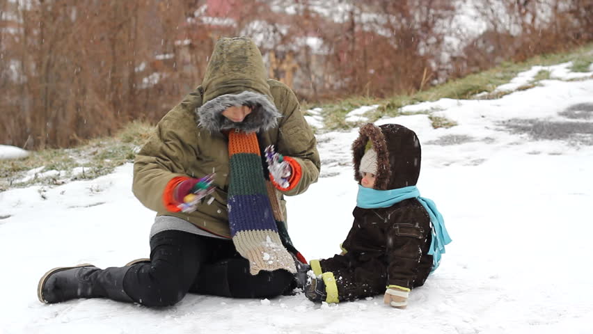 Mom showing her baby the snow