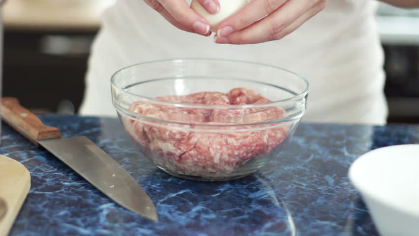 woman cooking cutlets in the kitchen