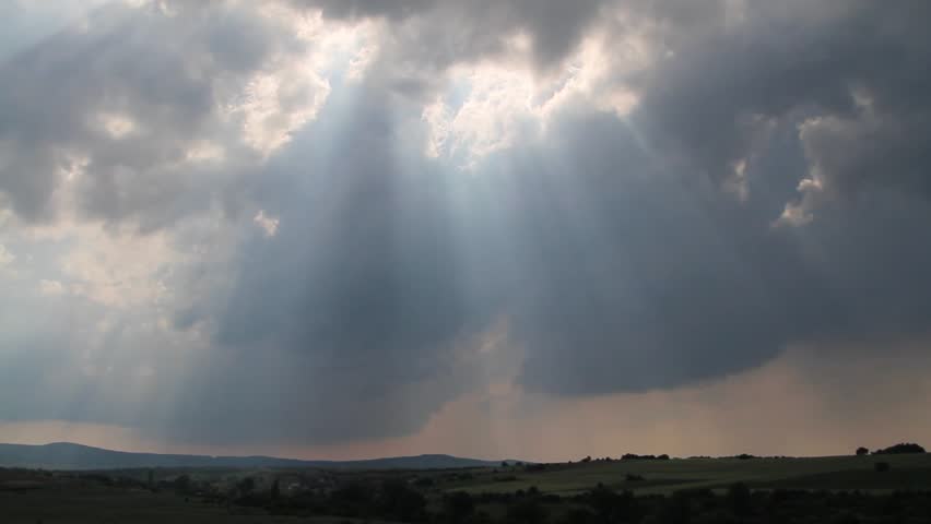 Sunbeams breaking trough the gaps of fast moving storm clouds over Thracian midlands, southeast Bulgaria.