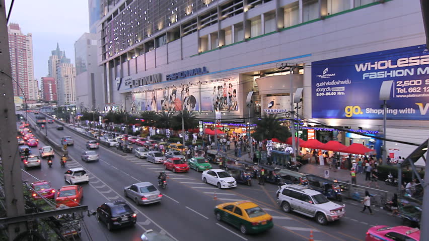 BANGKOK - DECEMBER 9: Rows of taxis, cars and tuk-tuk vehicles slowly passing in front of the Platinum Fashion Mall in Bangkok, Thailand on Dec 9, 2012. Pratunam market area is known for wholesale export oriented shops.