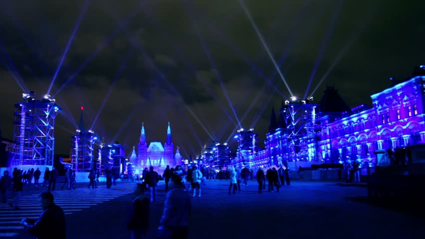 MOSCOW - OCT 21: Projectors rays above crowd on Red Square near GUM and Historical museum in Moscow during Circle of Light festival, open event, Oct 21, 2011, Moscow, Russia.
