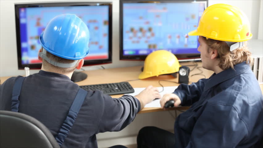Two workers talking about a job in a factory, controls the operation of devices in a power plant