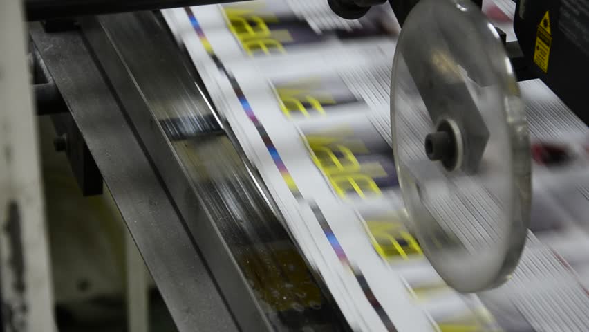 finished brochure magazine goes on the packaging line after it is printed on the web offset hit set press