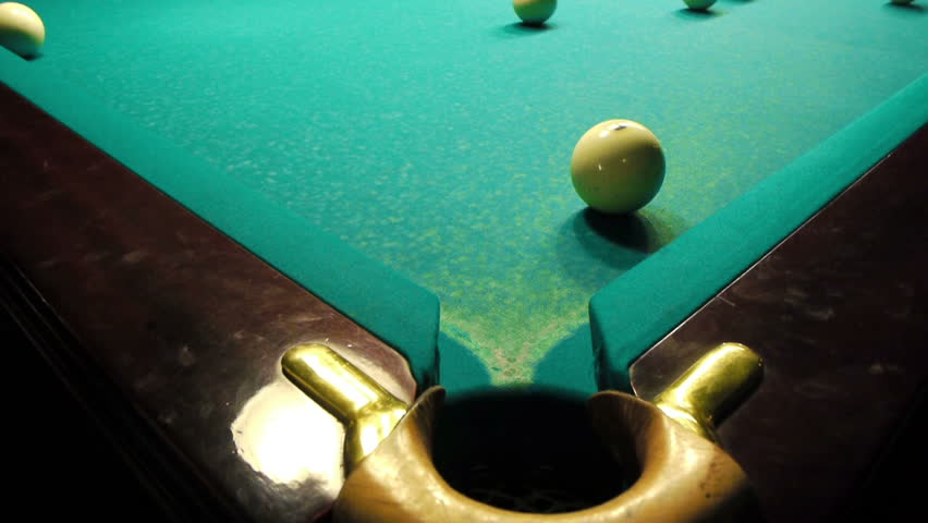 Playing pool, hitting the ball closeup view