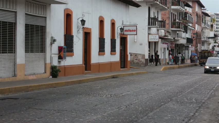 PUERTO VALLARTA, MEXICO NOV 2012: Mexican economy and tourism improves bringing increased traffic to business section of town. Busy Mexican street with traffic, cars and rucks. Fast dangerous driving.
