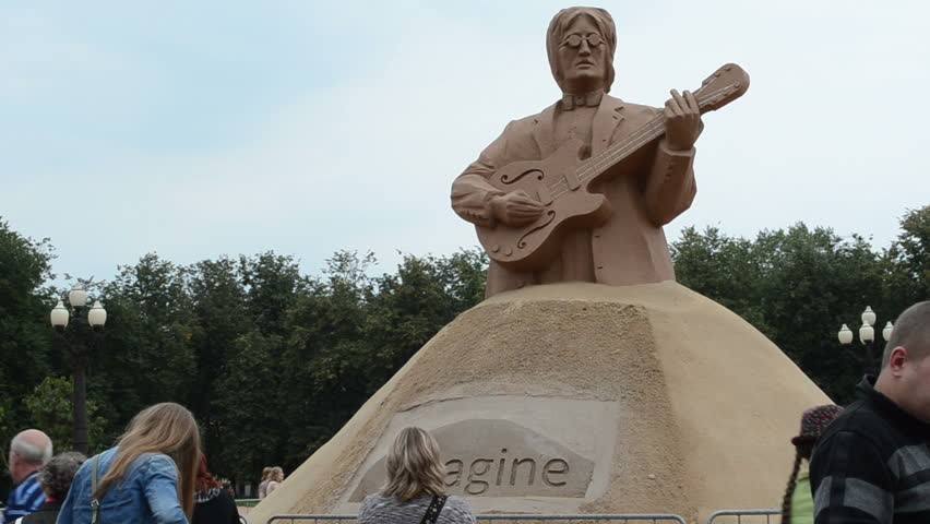 VILNIUS, LITHUANIA - SEPTEMBER 1: John Lennon legend beatles leader sculpture of sand imagine and people in Vilnius Lukiskiu square on September 1, 2012 in Vilnius. Vilnius city capital day.