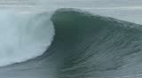 Close-up of a large, ocean storm wave breaking in slow motion off of the coast of central California.