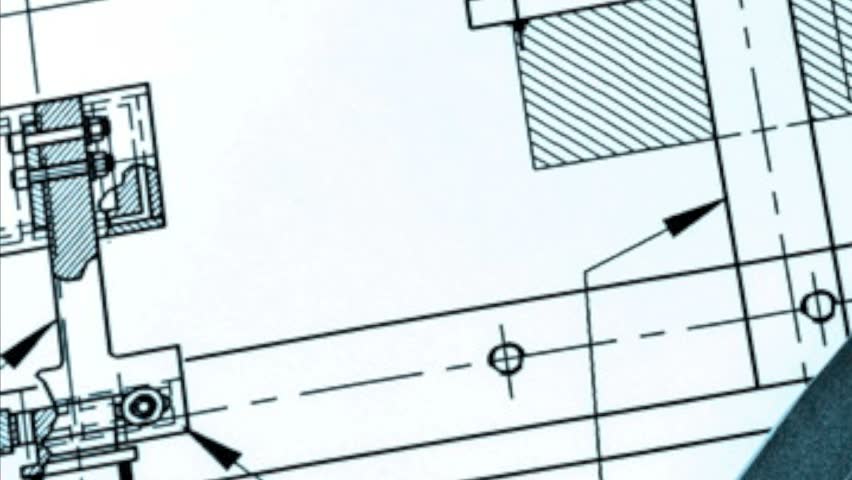 Drafting compass and ruler against a blueprint