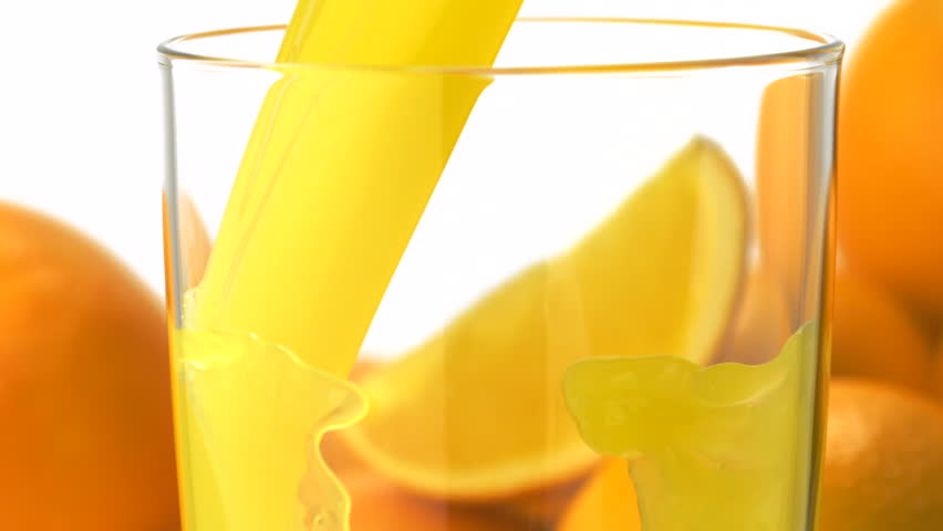 Pouring orange juice into glass shooting with a high speed camera.