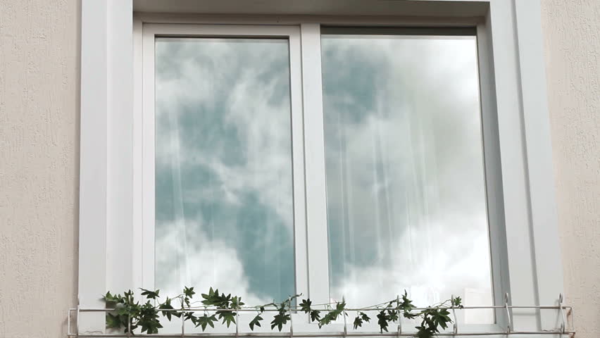 Home Exterior With Cloud Reflection In Plastic Window Frame