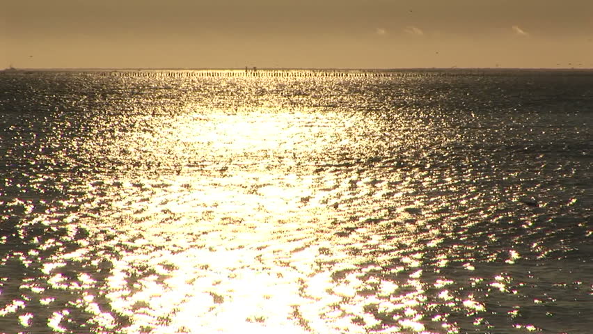 Golden sunlight at sundown on sea