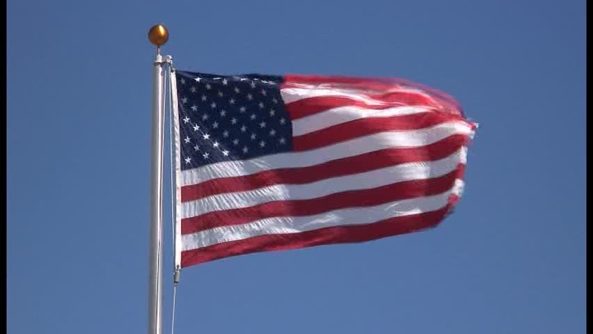 American flag blowing in strong wind on sunny day. New flag pole with nice brass top. thirty seconds,Locked Down, Medium Shot