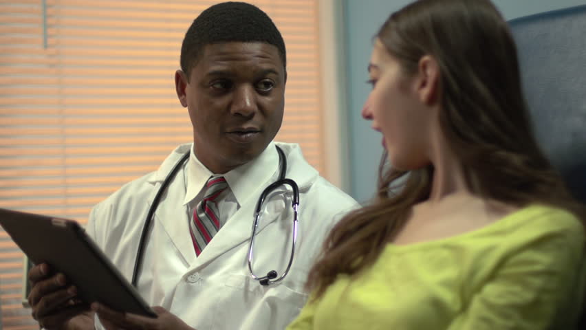 African American doctor using tablet to explain patient's condition