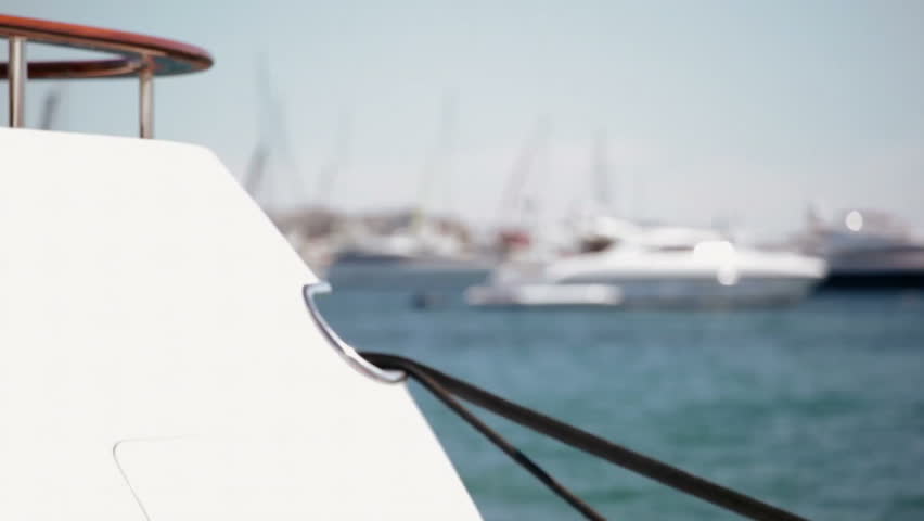 Luxury super yachts at anchor in Cannes, with focus pull both in and out of foreground yacht stern.