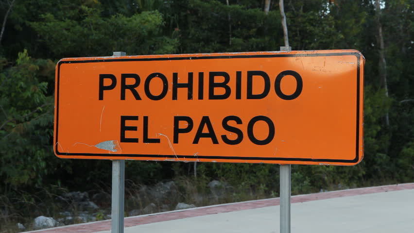 Road sign that says Prohibido el Paso, or Prohibited to Pass. Tulum, Quintana Roo, Mexico.
