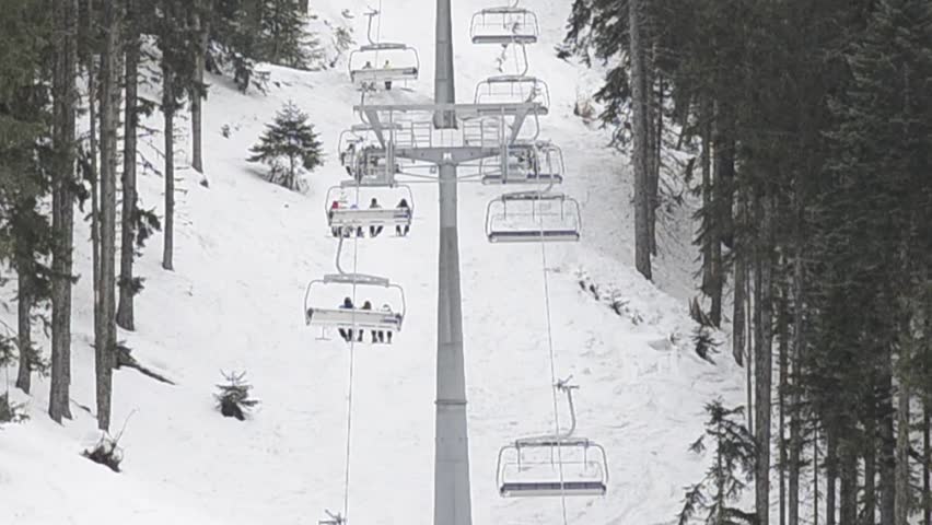 chair ski lift elevator lifting people on the mountain ski slope, Bansko, Bulgaria ski centre