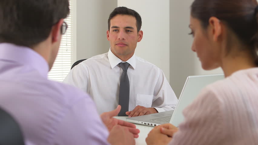 Latino businessman advising couple
