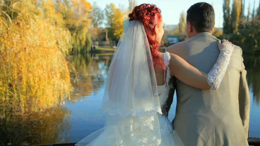 Newlyweds embracing in the park