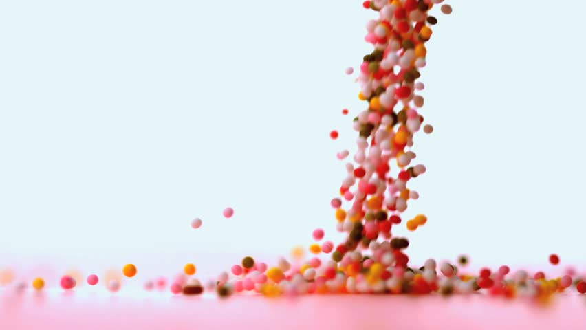 Sprinkles Falling Onto Blue Surface In Slow Motion Stock Footage Video