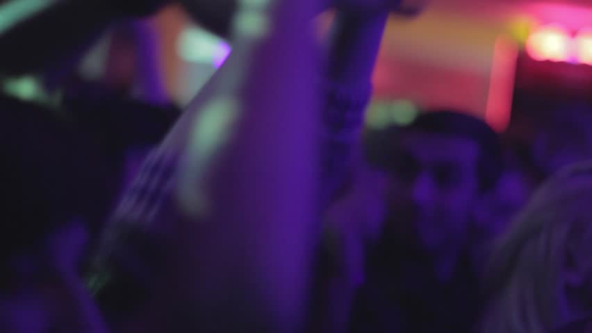 Hands clapping close-up. People dancing in nightclub.