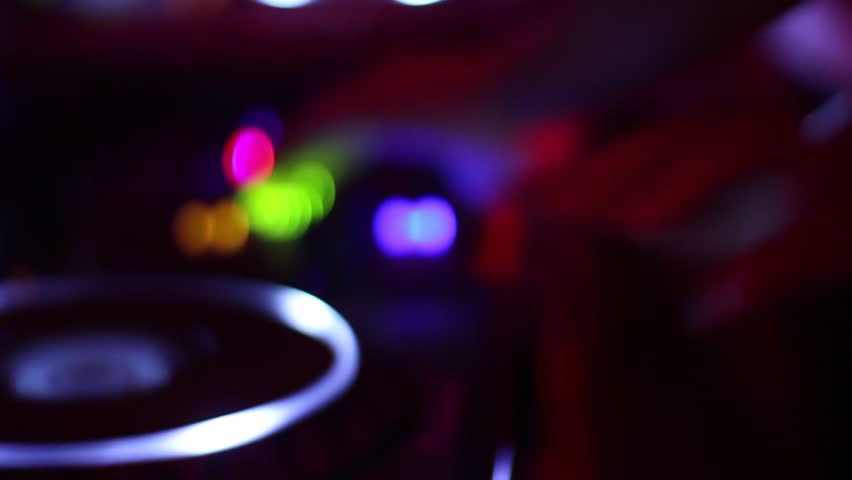 Female dj hands crossed tweaking mixer controls, playing music in nightclub