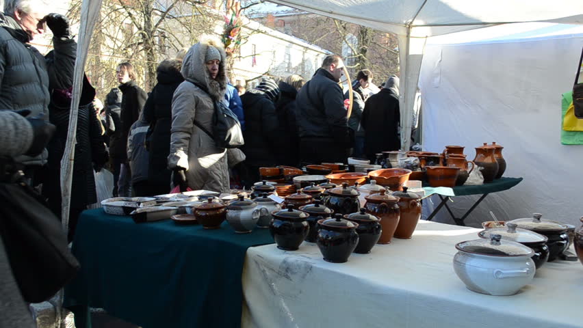 VILNIUS, LITHUANIA - MARCH 02: People look at crockery pots goods in outdoor national spring fair on March 02, 2012 in Vilnius. Traditional crafts and sell exhibition.
