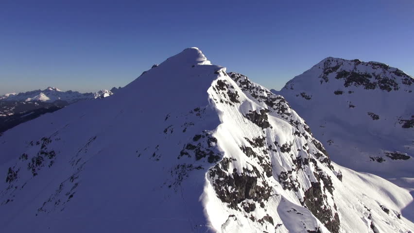 flying near rocky mountains covered with snow