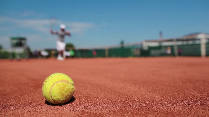 On the tennis court - personal trainer training a tennis player