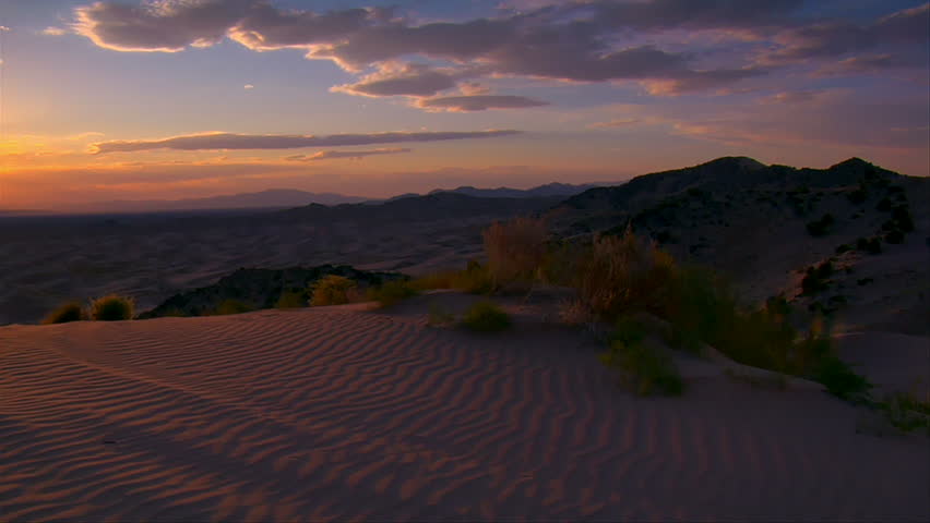 tilts up from sand dunes's to gorgeous desert sunset