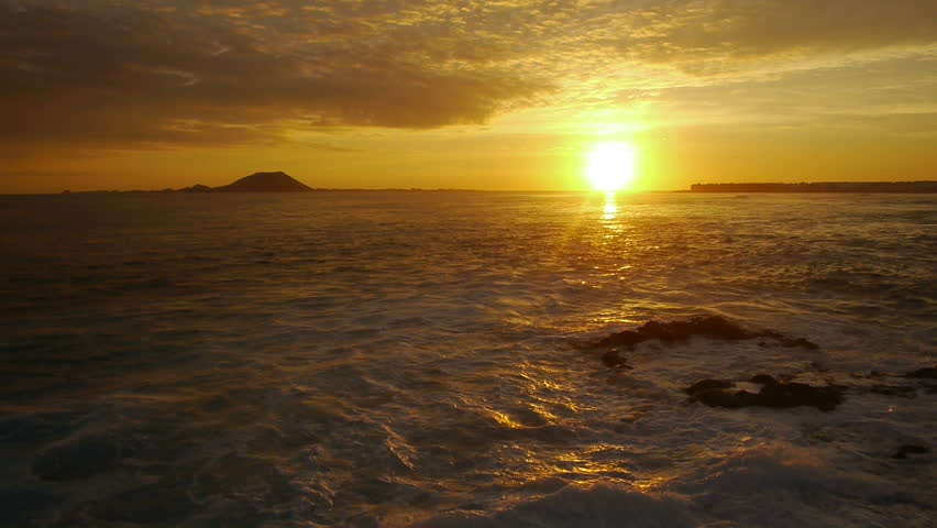 AERIAL: Golden sunset at seaside