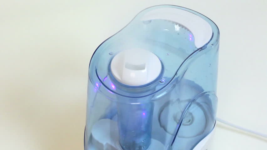Air humidifier. Steam evaporation. Water drops on its surface.